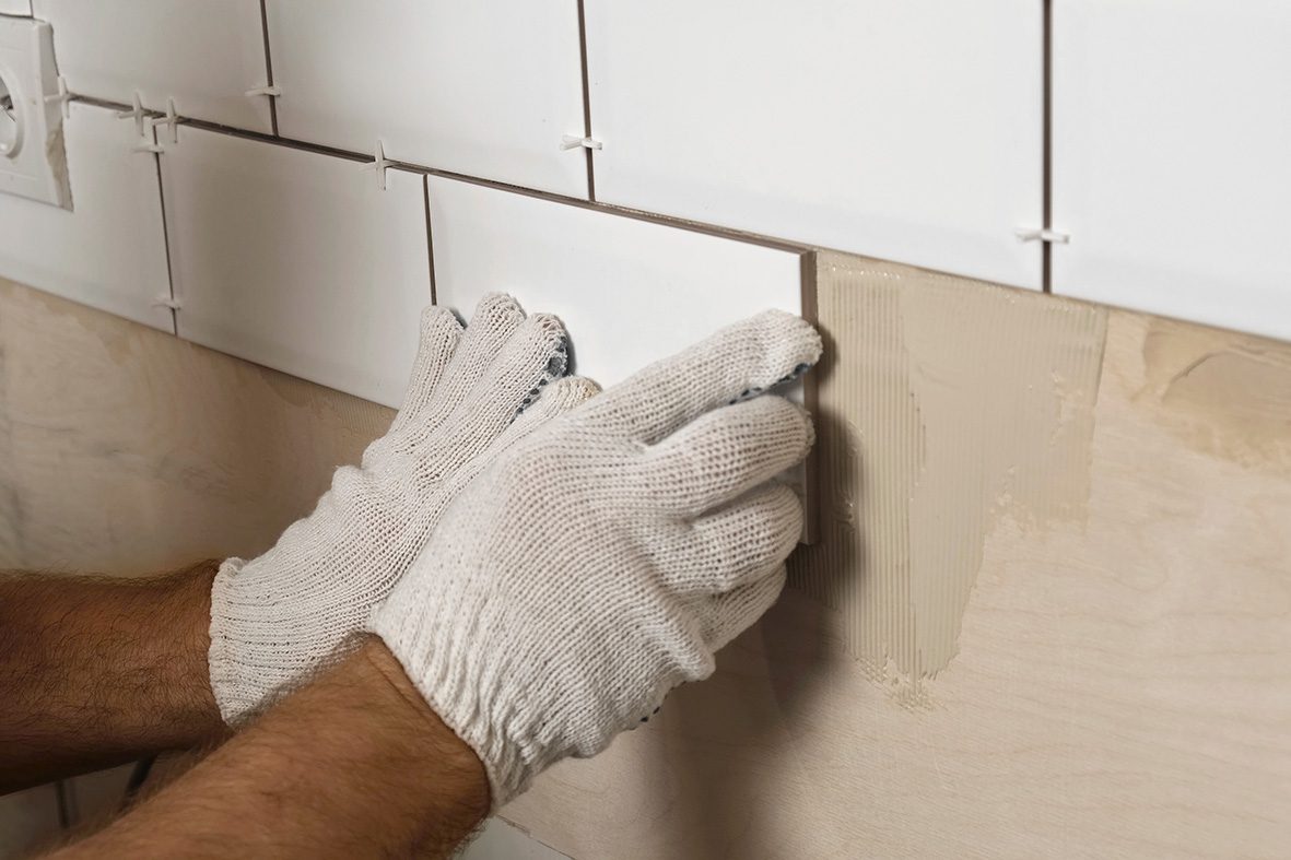 Male,Worker,Master,Laying,Ceramic,Tiles,On,The,Wall,Of